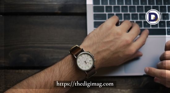 Person checking time while working on a laptop — symbolizing productivity and time management in entrepreneurship.