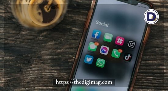 Cell phone displaying social media icons representing digital marketing platforms