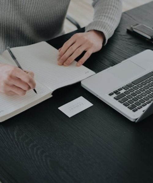 A person taking notes from Free Online Course